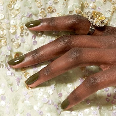 Dark skin model wearing nail polish in the shade meet me at midnight and a sequined off-white dress