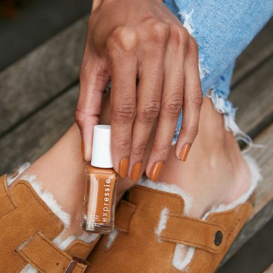 Medium skin model wearing nail polish in saffr-on the move and slide-on shoes in a similar shade