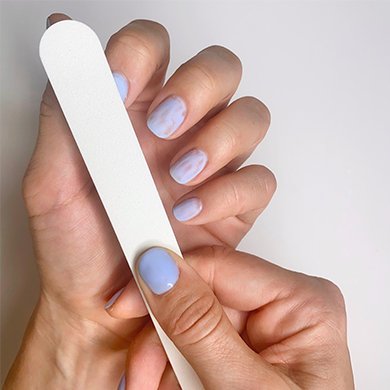 file nail surface to remove shine and top layer of purple nail color