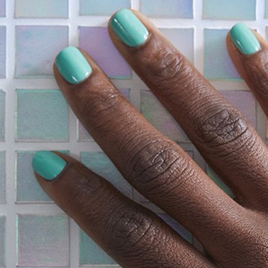 Model wearing essie’s it’s high time mint green nail polish.