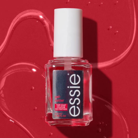 Bottle of essie gel setter top coat against a red background with shiny clear nail polish puddles