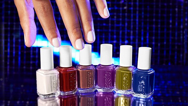 Light skin hand reaching down for the 6 bottles of essie fall 2023 shades