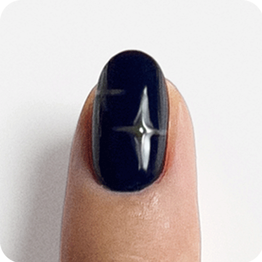 Light skin fingernail in green meet me at midnight polish cross edges curved to form a star