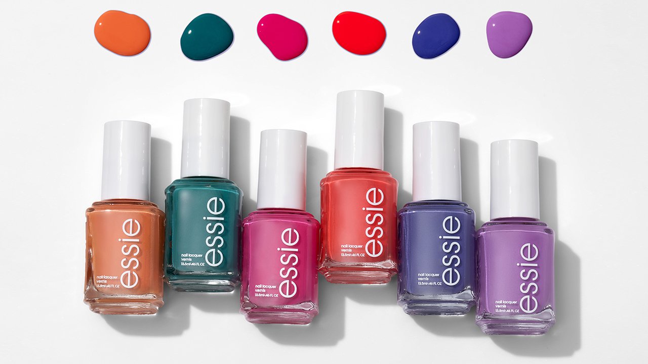 Six different bottles of essie nail polish with corresponding pools of nail polish above each bottle